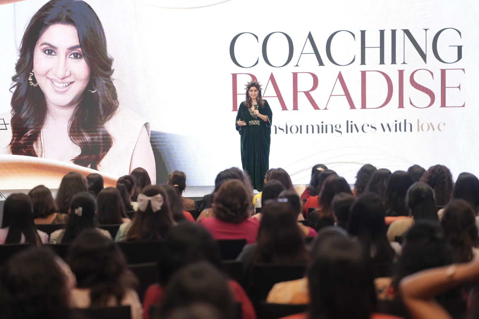 Puja Ma'am speaking on the grand stage