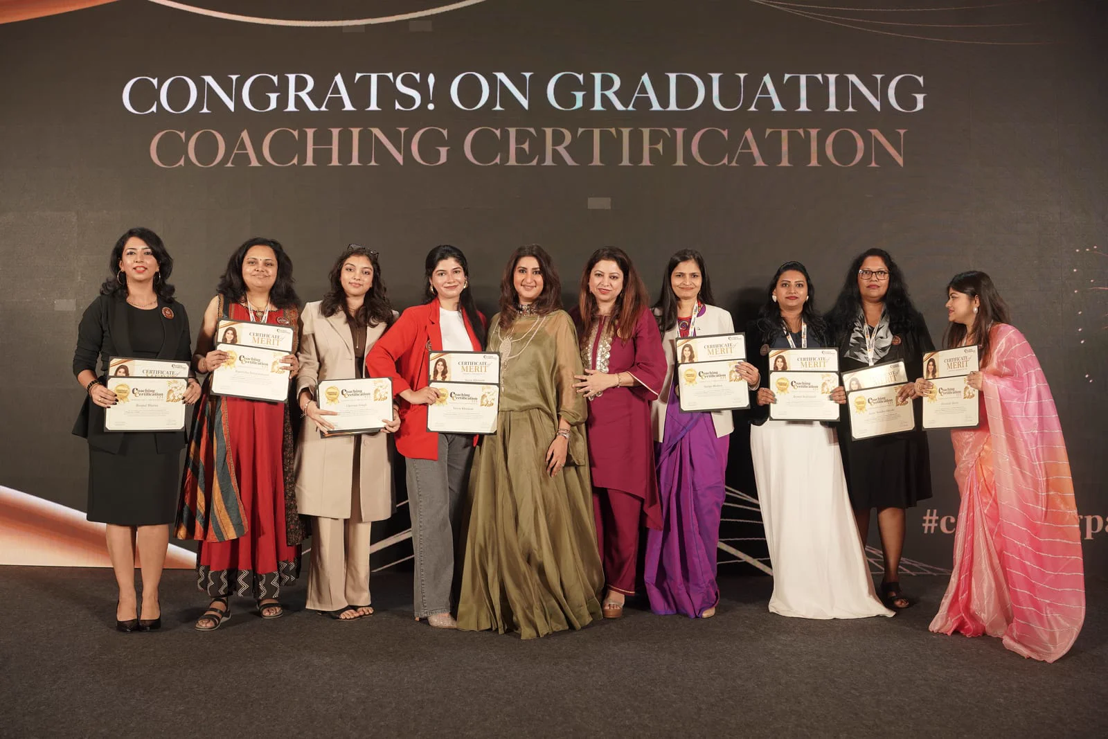 Puja presenting certificates on stage